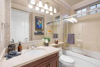 a bathroom with a sink and a toilet and a mirror at NEW Private 1BR Near Kerrisdale and UBC w Laundry in Vancouver