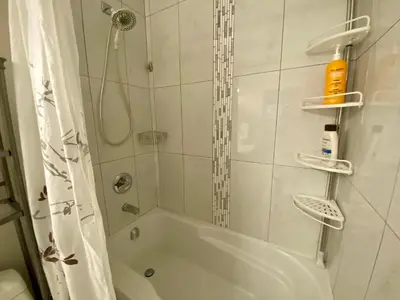a bathroom with a shower and a white tub at Ridge Pointe Retreat Your Victoria Hideaway in Colwood
