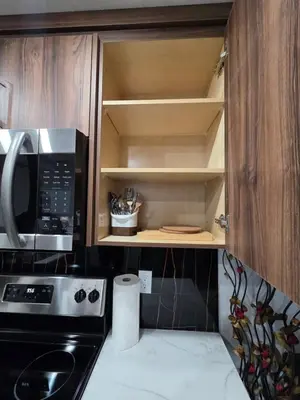 a kitchen with a stove and a microwave at YYC Cozy Suites in Calgary