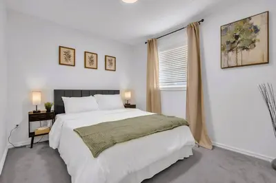 a bedroom with a large white bed and a window at Home Theater•Luxury•Entire4BHome•GamesRoom•KingBed in Edmonton