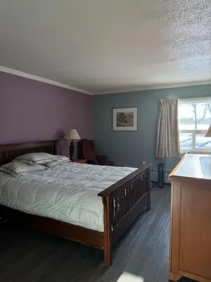 a bedroom with a large bed and a window at Country Road Motor Inn