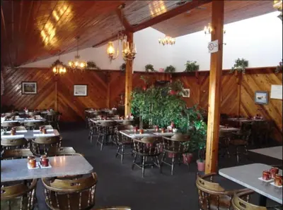 a dining room with tables and chairs in it at Country Road Motor Inn