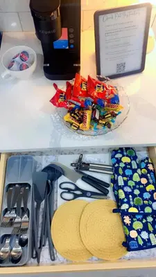 a drawer filled with utensils and a plate of food at Brand New cozy apartment bright, modern private 2 bedroom basement! in Calgary