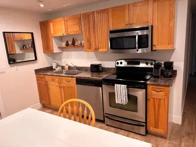 a kitchen with a stove and a microwave at Sumas Mountain basement suite in Abbotsford