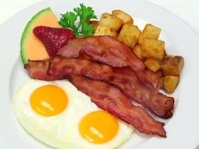 a plate of breakfast food with eggs bacon and potatoes at Hotel 11, MOD A Sonesta Collection in Calgary
