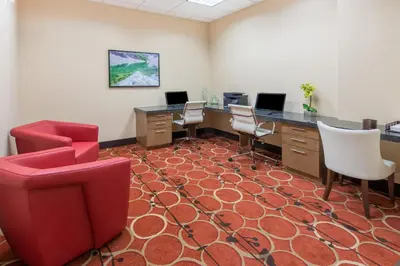 an office with chairs and desks in a room at Hotel 11, MOD A Sonesta Collection in Calgary
