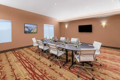a conference room with a long table and chairs at Hotel 11, MOD A Sonesta Collection in Calgary
