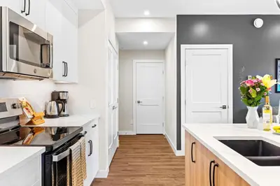 a kitchen with white counters and white appliances at Tranquil 2BR Golden Oasis BBQ, Balcony, MTN Views in Golden