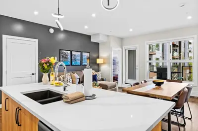 a kitchen with a sink and a living room at Tranquil 2BR Golden Oasis BBQ, Balcony, MTN Views in Golden
