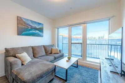 a living room with a couch and a large window at Modern 2BR in Golden w/ Stunning MTN Views! in Golden