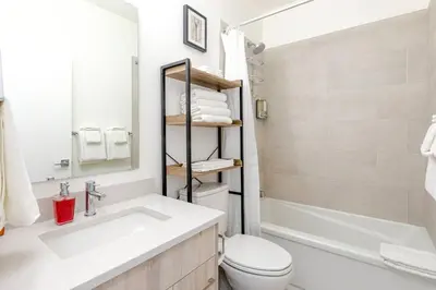 a bathroom with a sink and a toilet and a tub at Modern 2BR in Golden w/ Stunning MTN Views! in Golden