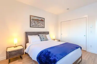 a bedroom with a large bed and two lamps at Modern 2BR in Golden w/ Stunning MTN Views! in Golden