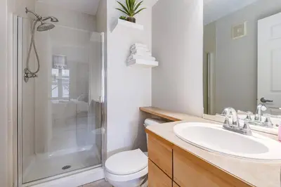 a bathroom with a toilet and a sink and a shower at Charming 2BR Condo with Spectacular Mountain Views in Canmore