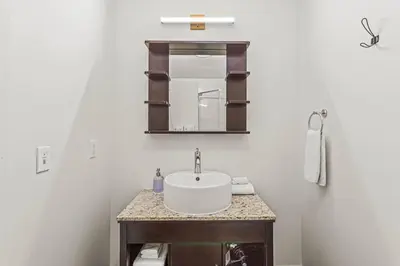 a bathroom with a sink and a mirror at Rockies Getaway Condo With Mountain View in Canmore