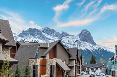 a mountain in the background of a town with houses at Renovated Haven in Rockies with Hot Tub and Pool in Canmore