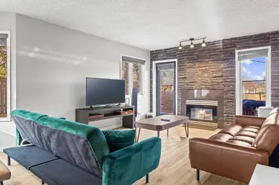 a living room with a couch and a fireplace at 2BR Bow Valley Retreat with BBQ Near Parks and Banff in Canmore