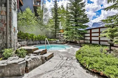 a swimming pool in the backyard of a house at Relaxing 1BR Getaway Hot tub plus Amazing Mtn Views in Canmore