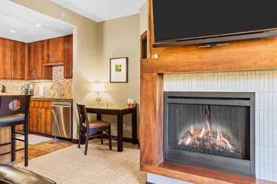 a living room with a fireplace with a tv at Ideal 2BR Canmore Haven Hot Tub plus Stunning Views in Canmore