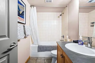 a bathroom with a sink and a toilet and a tub at Peaceful 2BR Retreat with MTN Views Close to Banff in Canmore