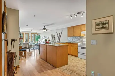 an open kitchen and dining room with a kitchen island at Rustic Creekside Retreat 2BR with Stunning View in Canmore