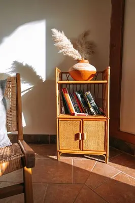 a book shelf with books and a vase on it at First Light - Vintage waterfront with hot tub - One Bedroom in Tofino