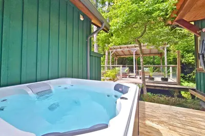 a bath tub sitting outside of a green building at Cedar and Salt in Tofino