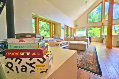 a stack of books sitting on a table in a living room at Cedar and Salt in Tofino
