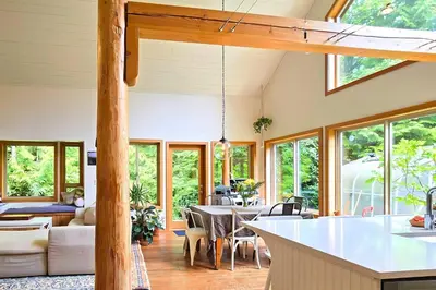 a kitchen and living room with a table and chairs at Cedar and Salt in Tofino