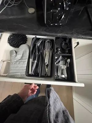 a person is sitting inside of a kitchen drawer at Jaspers Seaside Resort complex, in Courtenay
