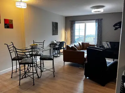 a living room with a couch and a table and chairs at Jaspers Seaside Resort complex, in Courtenay