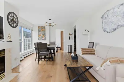 a living room with a couch and a table at Downtown Skyline Suite with Pool & Sauna in Vancouver