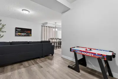 a living room with a couch and a ping pong table at The Cabin Sleep in Edmonton