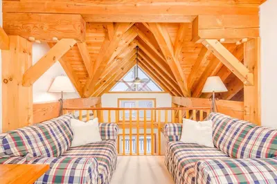 a living room with two couches and a wooden ceiling at Alpine Timbers 2 Luxury Chalet with Hot Tub in Big White