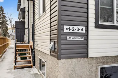 a house with a sign on the side of it at Honeyville House Sleeps 8 Pool Table in Edmonton