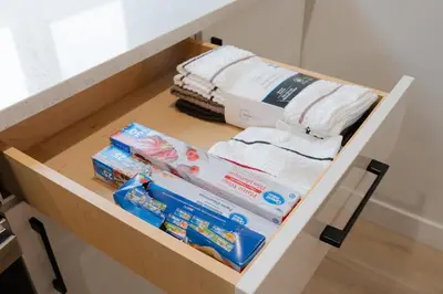 a drawer with towels and other items in a bathroom at Honeyville House Sleeps 8 Pool Table in Edmonton