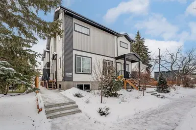 a large house with snow on the ground at Honeyville House Sleeps 8 Pool Table in Edmonton