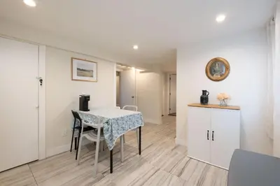 a kitchen and dining room with a table and chairs at Quiet 5 BR 7 bed Escape with sunny Deck near UBC in Vancouver