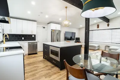a kitchen and dining room with a glass table at Edmonton Home in Edmonton