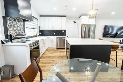 a kitchen with a table and a counter top at Edmonton Home in Edmonton