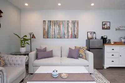 a living room with a couch and a table at Luxury Modern 2-Bedroom Suite Near Transit & Shops in White Rock