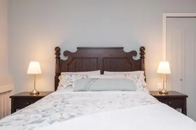 a bedroom with a large bed with two lamps at Luxury Modern 2-Bedroom Suite Near Transit & Shops in White Rock