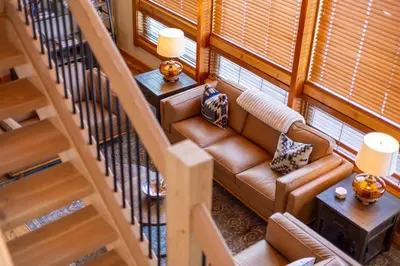 an overhead view of a living room with a couch and stairs at Elk River Estate by Fernie Central Reservations in Fernie