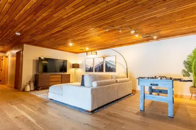 a living room with a couch and a table at Elk River Estate by Fernie Central Reservations in Fernie