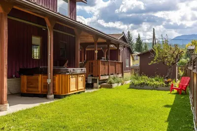 a house with a hot tub on a yard at Huckleberry Lodge by Fernie Central Reservations in Fernie
