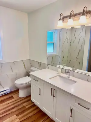 a bathroom with a toilet and a sink and a mirror at Harbourview Hideaway Sooke in Sooke