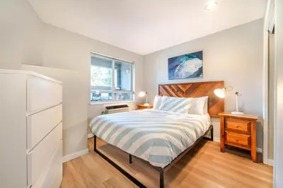 a small bedroom with a bed and a dresser at 1BR+Sofabed | Deer Lodge | Epic Village Location | Covered Patio | Ski Locker | Fireplace | Parking in Whistler