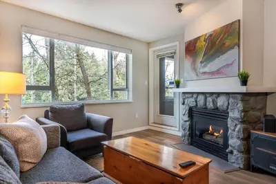 a living room with a fireplace and a couch at 1BR+Sofabed | Deer Lodge | Epic Village Location | Covered Patio | Ski Locker | Fireplace | Parking in Whistler