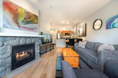 a living room with a couch and a fireplace at 1BR+Sofabed | Deer Lodge | Epic Village Location | Covered Patio | Ski Locker | Fireplace | Parking in Whistler