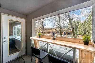 a large window in a room with a table and chairs at 1BR+Sofabed | Deer Lodge | Epic Village Location | Covered Patio | Ski Locker | Fireplace | Parking in Whistler