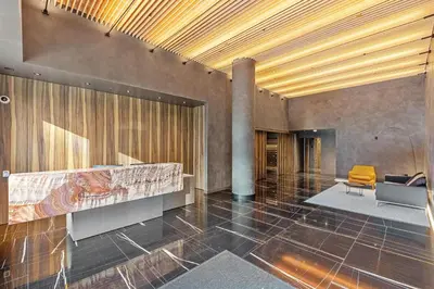 a lobby with a reception desk and a chair at Modern Brand New 1-Bedroom Condo in Downtown in Vancouver